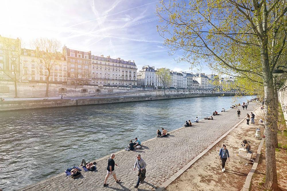 The River Seine walkway with Parisians relaxing, Paris, France