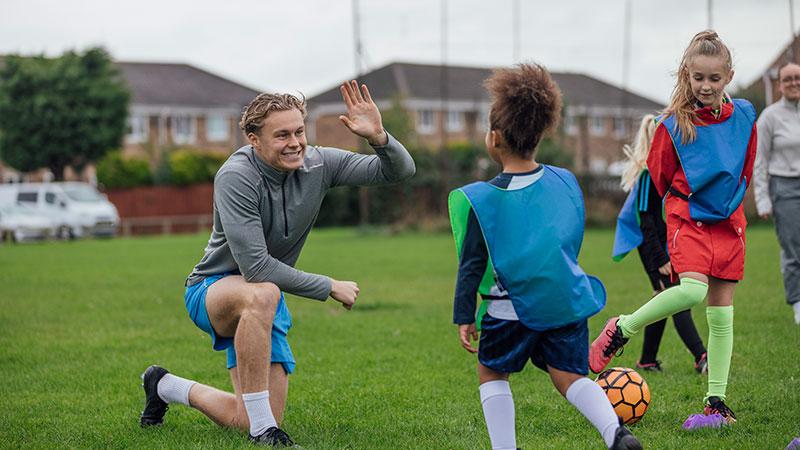 coach gives high fives to players